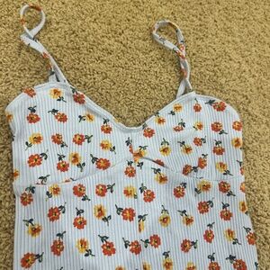 out from under blue floral bodysuit